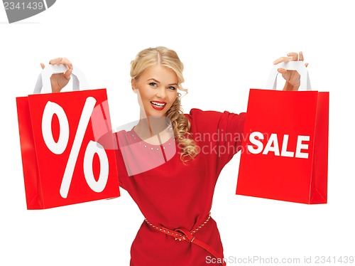 Image of beautiful woman in red dress with shopping bag