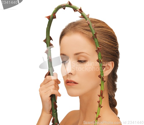 Image of woman holding branch with thorns