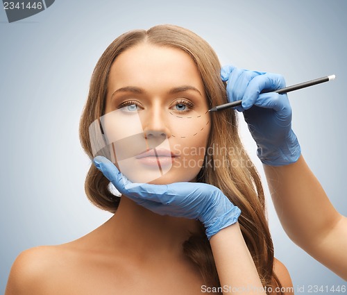Image of woman face and beautician hands