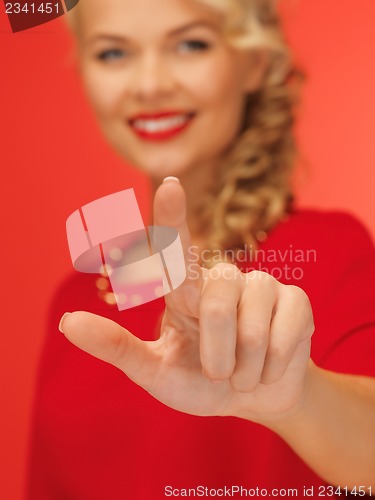 Image of woman in red dress pressing virtual button