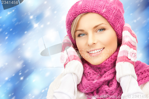Image of beautiful woman in hat, muffler and mittens
