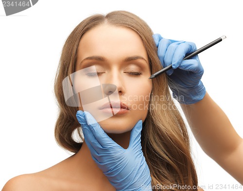 Image of woman face and beautician hands