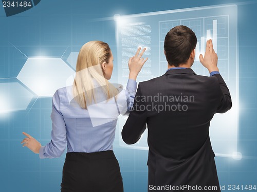 Image of man and woman working with virtual screens