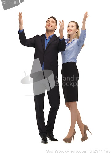 Image of man and woman making a greeting gesture