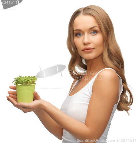 Image of woman with green grass in pot
