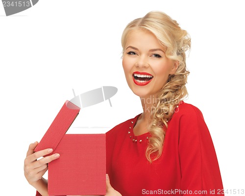 Image of lovely woman in red dress with opened gift box