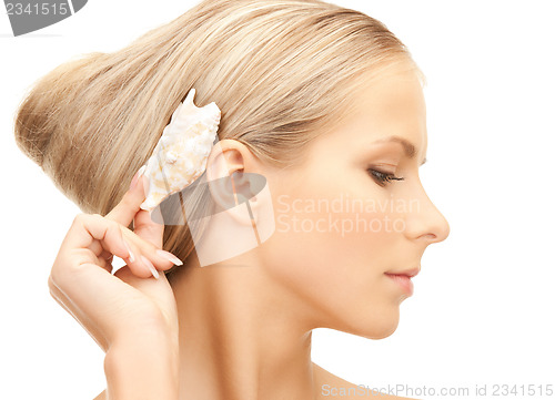 Image of beautiful woman with seashell