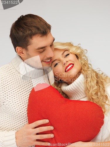 Image of family couple in a sweaters with heart