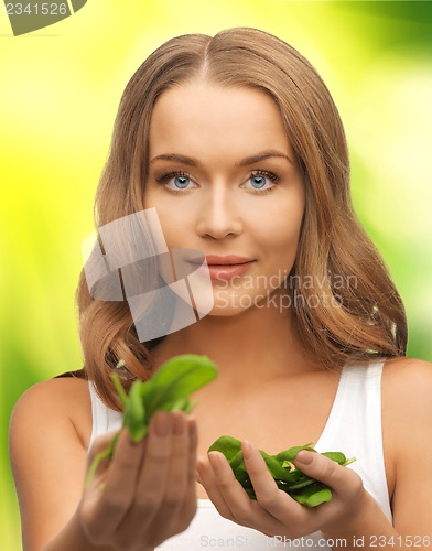 Image of woman with spinach leaves on palms