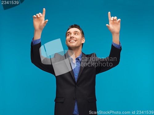 Image of man in suit working with something imaginary