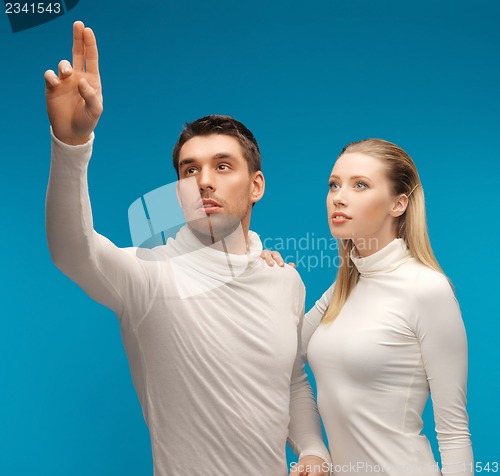 Image of man and woman working with something imaginary