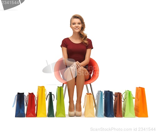 Image of teenage girl in red dress with shopping bags