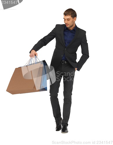 Image of handsome man in suit with shopping bags