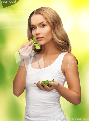 Image of woman with spinach leaves on palms