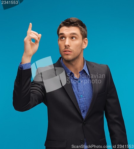 Image of man in suit with his finger up