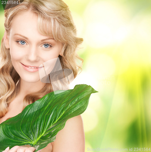 Image of woman with green leaf