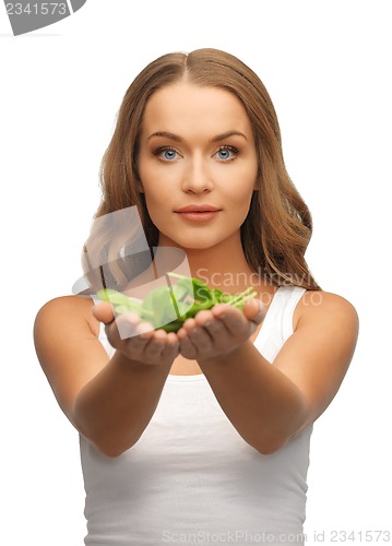 Image of woman with spinach leaves on palms