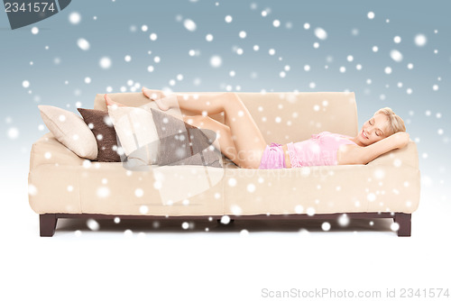 Image of sleeping woman on sofa with snow