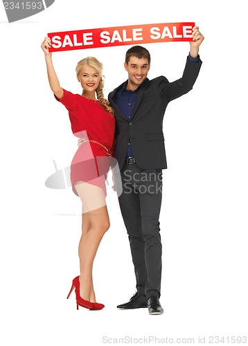 Image of man and woman with sale sign