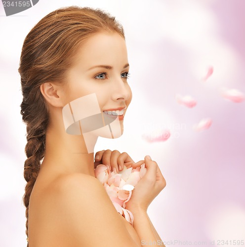 Image of beautiful woman with rose petals