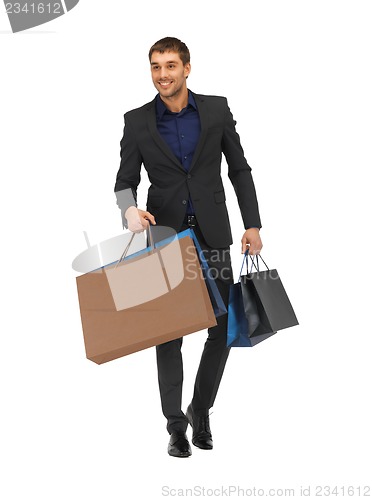 Image of handsome man in suit with shopping bags