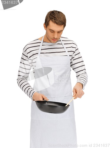 Image of handsome man with pan and spoon