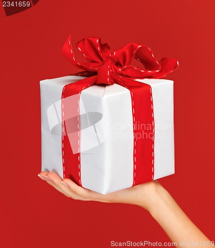 Image of woman's hands holding a gift box