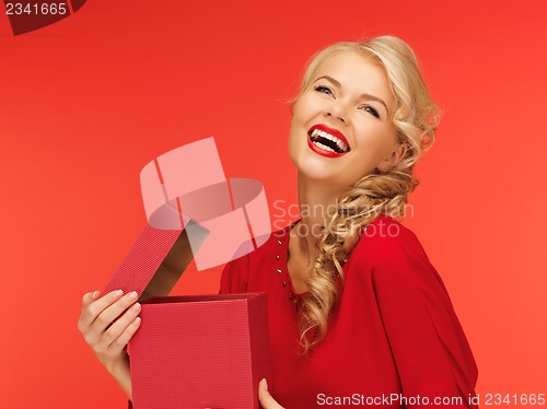 Image of lovely woman in red dress with opened gift box