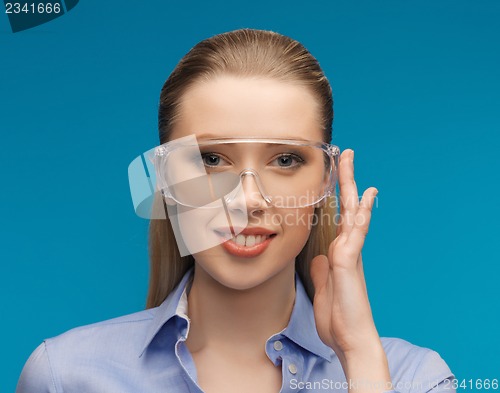 Image of businesswoman in protective glasses