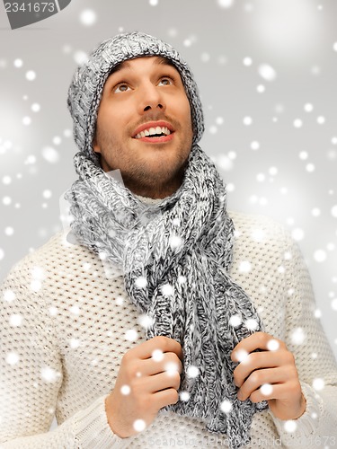 Image of handsome man in warm sweater, hat and scarf