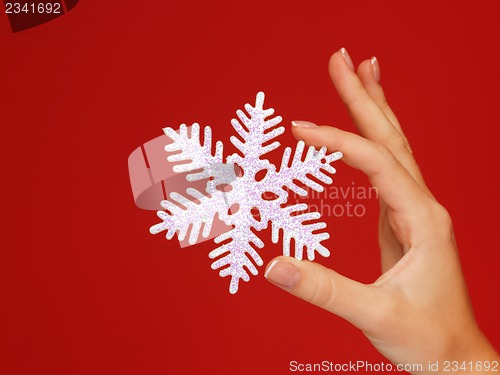 Image of woman's hands holding a snowflake