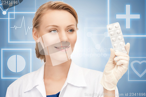 Image of attractive female doctor with pills