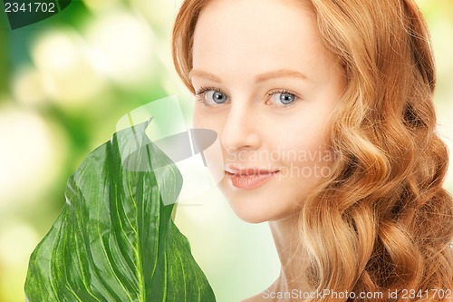 Image of woman with green leaf