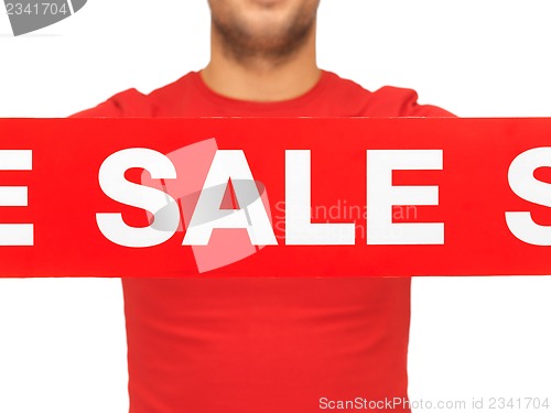 Image of man holding sale sign