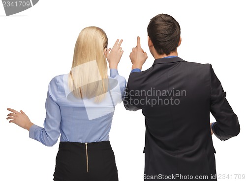 Image of man and woman working with something imaginary