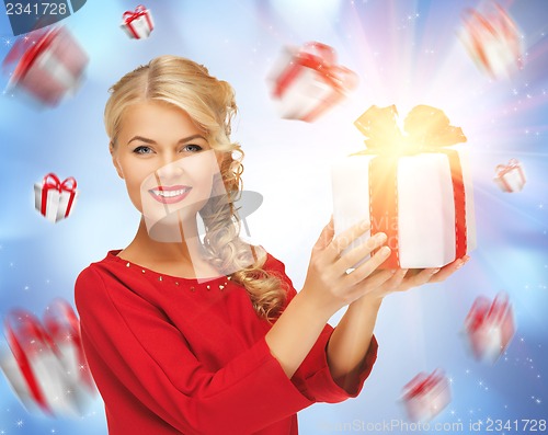 Image of lovely woman in red dress with present