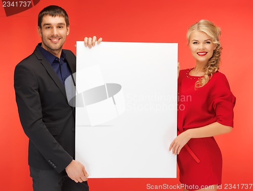 Image of couple holding big blank board