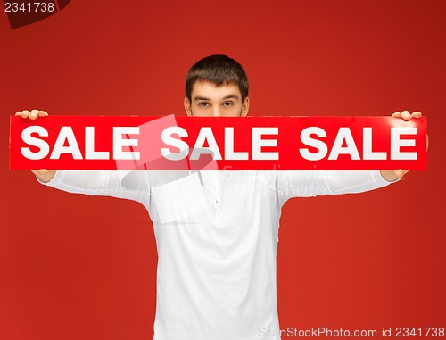 Image of man holding sale sign