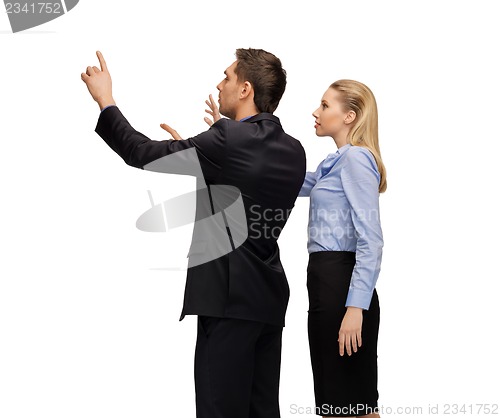 Image of man and woman working with something imaginary