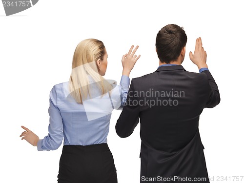 Image of man and woman working with something imaginary