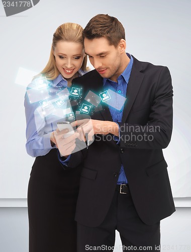 Image of man and woman reading sms
