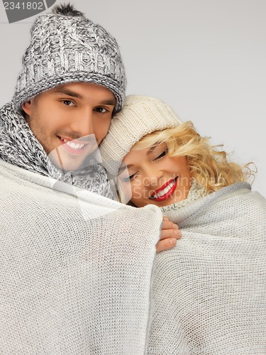 Image of family couple under warm blanket