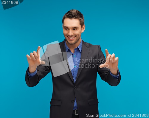 Image of man in suit working with something imaginary