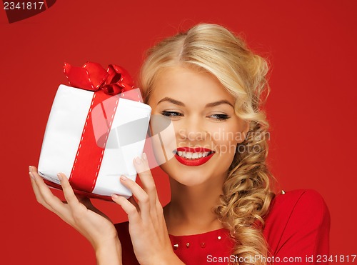 Image of lovely woman in red dress with present