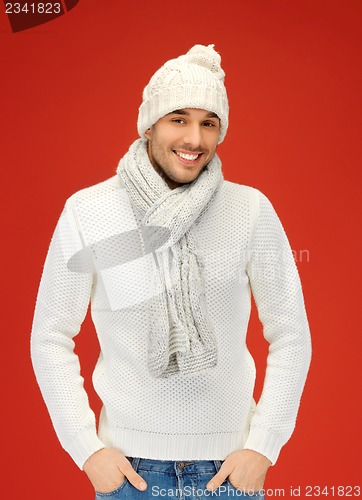 Image of handsome man in warm sweater, hat and scarf