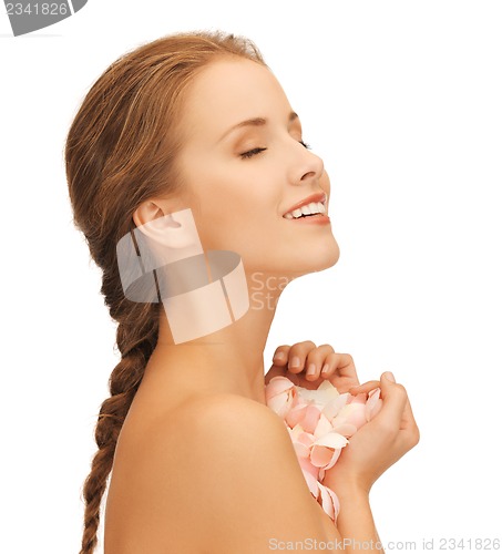 Image of beautiful woman with rose petals
