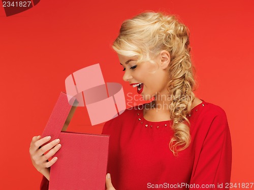 Image of lovely woman in red dress with opened gift box