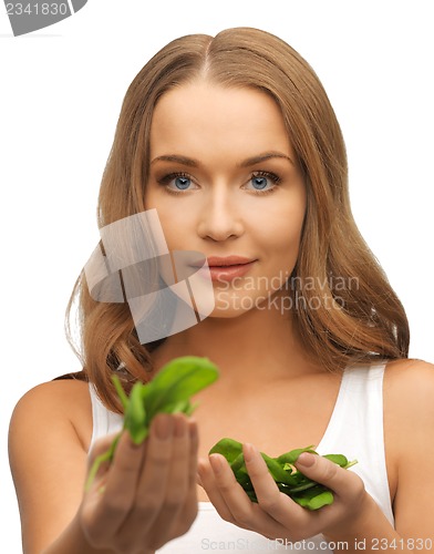 Image of woman with spinach leaves on palms