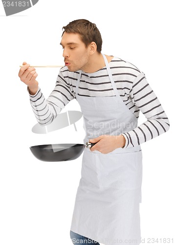 Image of handsome man with pan and spoon