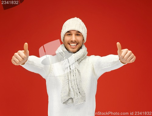 Image of handsome man in warm sweater, hat and scarf